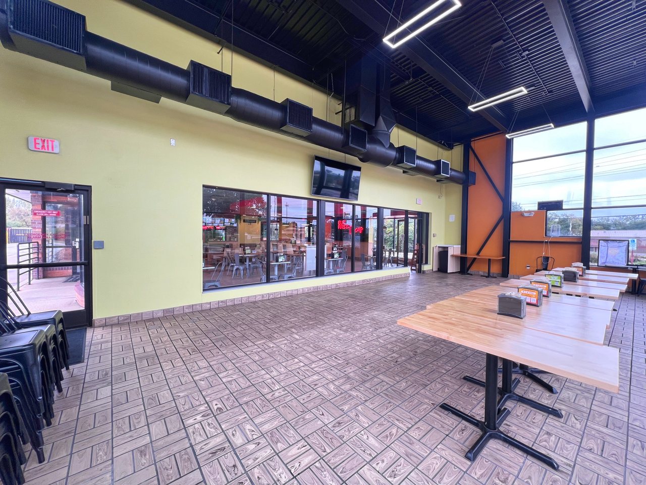 Urbandale Party Room with tables, a closing door and interior windows overlooking the restaurant