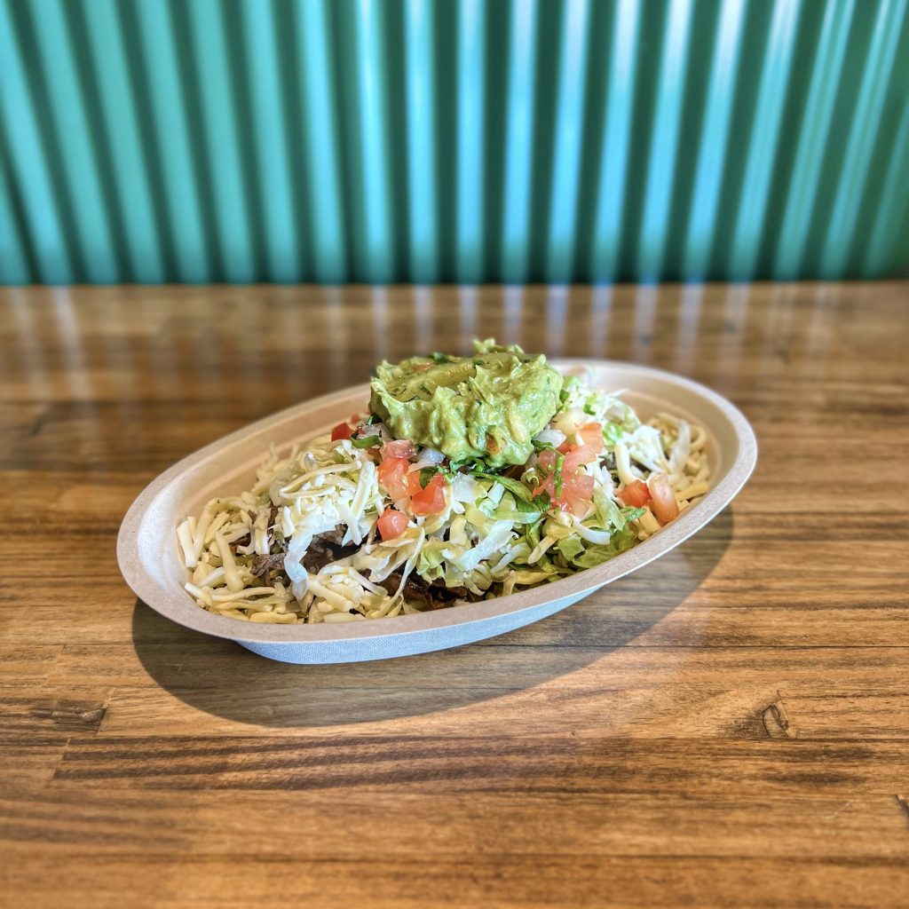 TNT bowl with rice, beans, protein, and toppings in Olathe, KS